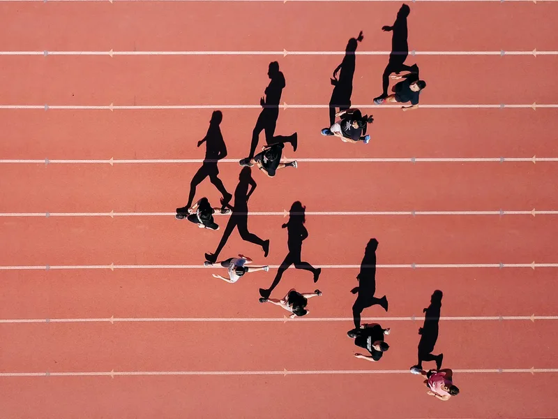 Runners spread across the lanes of a track, seen from above